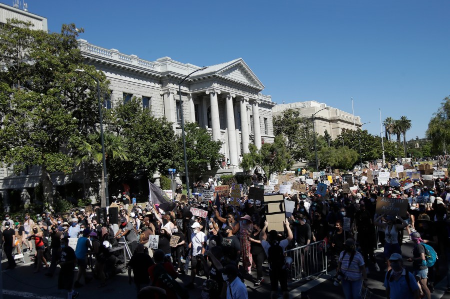 People march down a street in Martinez on July 12, 2020, during a protest calling for an end to racial injustice and accountability for police. (AP Photo/Jeff Chiu)