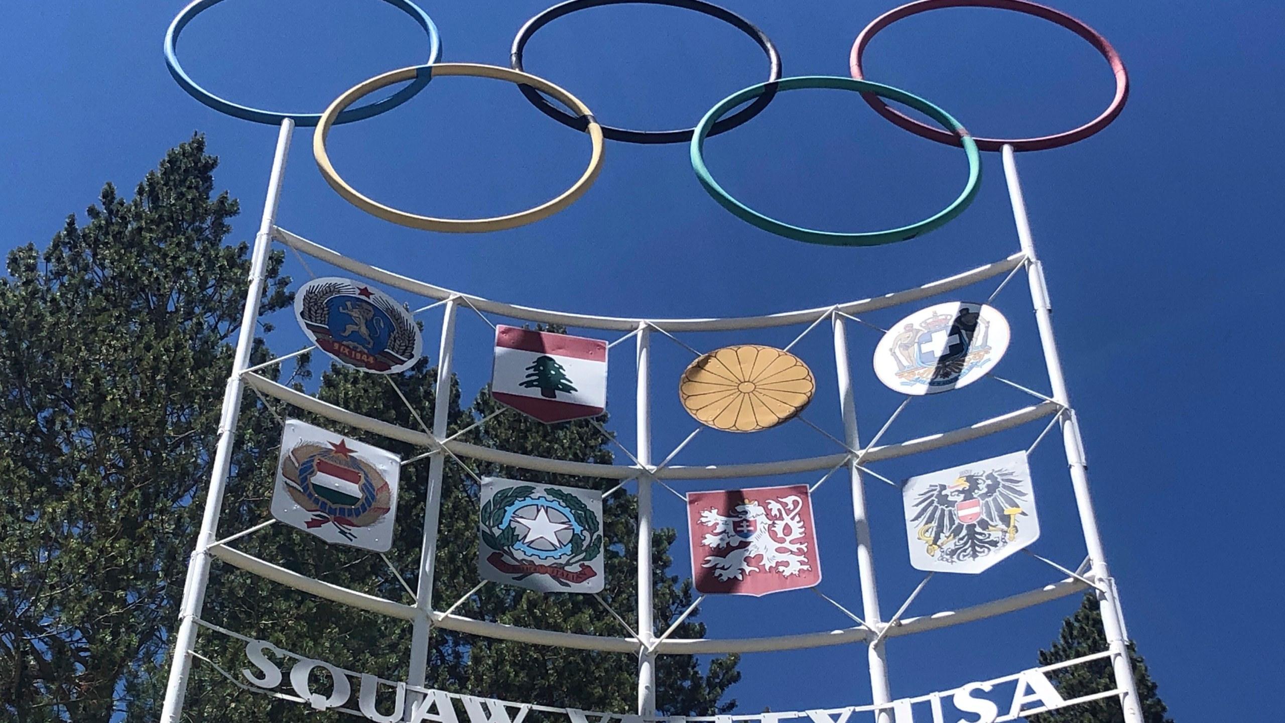 The Olympic rings stand atop a sign at the entrance to the Squaw Valley Ski Resort in Olympic Valley on July 8, 2020. (AP Photo/Haven Daley)