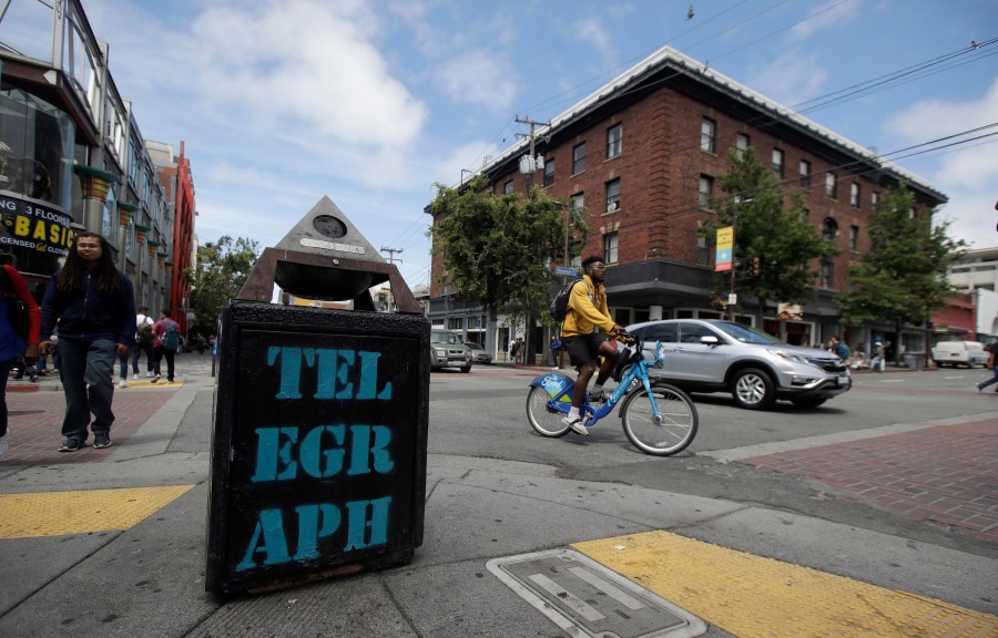 In this file photo from July 18, 2019, traffic and pedestrians cross Telegraph Avenue in Berkeley. (AP Photo/Jeff Chiu, File)