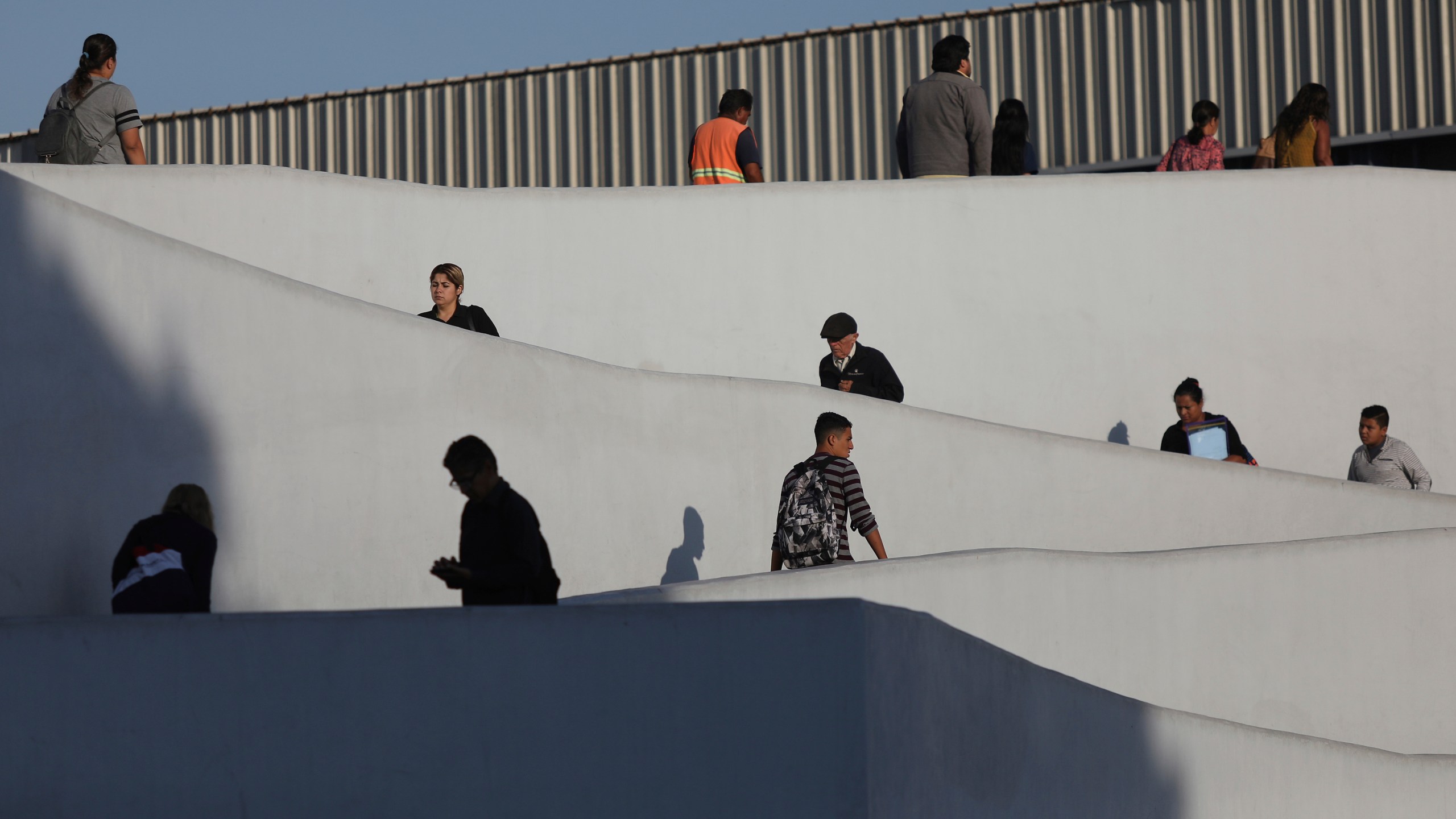 In this Sept. 13, 2019, photo, people use the legal border crossing into the United States, on the U.S.- Mexico border in Tijuana, Mexico. (AP Photo/Emilio Espejel, File)