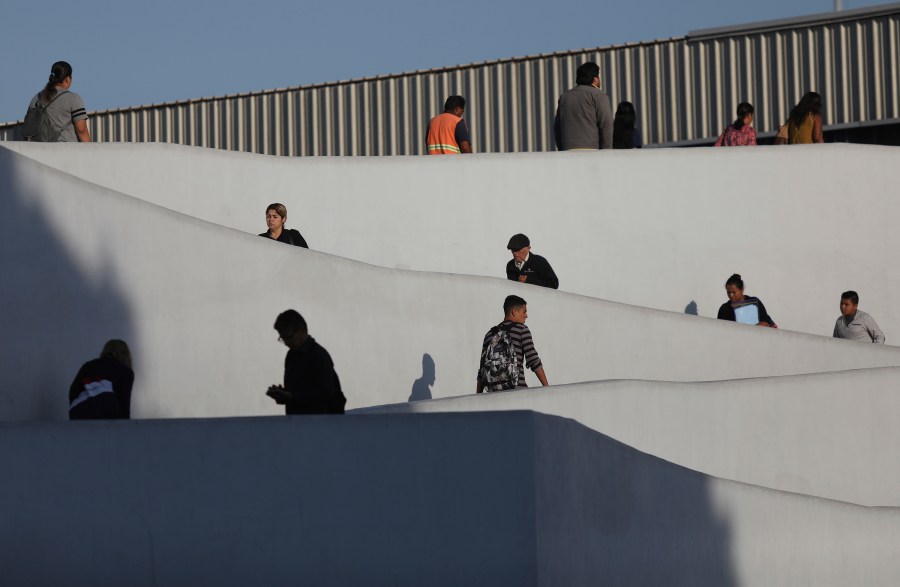 In this Sept. 13, 2019, photo, people use the legal border crossing into the United States, on the U.S.- Mexico border in Tijuana, Mexico. (AP Photo/Emilio Espejel, File)