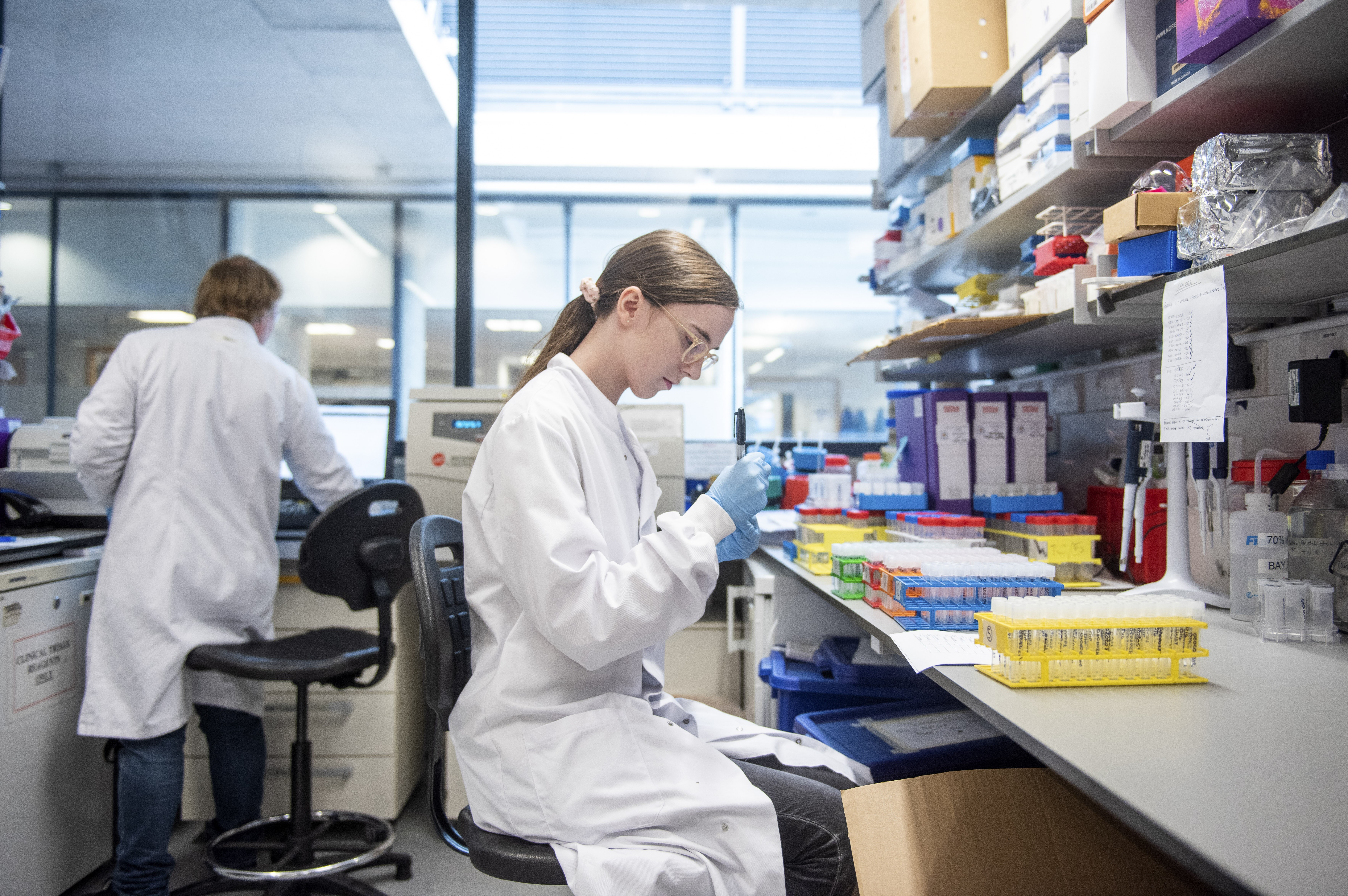 In this handout photo released by the University of Oxford, blood samples from coronavirus vaccine trials are handled inside the Jenner Institute in Oxford, England on June 25, 2020. (Cairns, University of Oxford via AP)