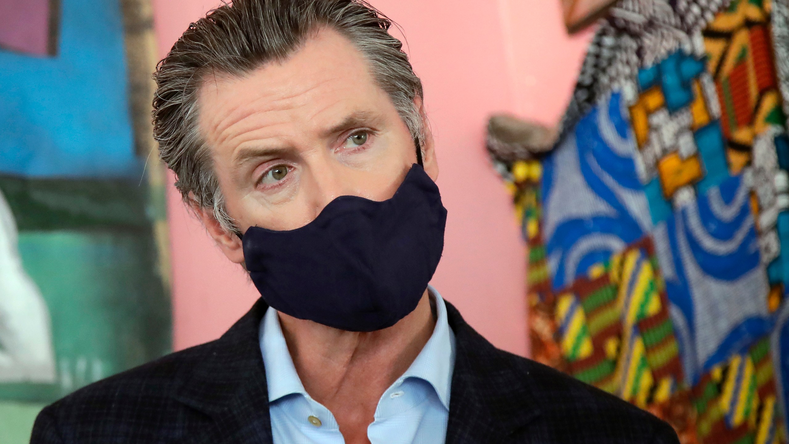 In this June 9, 2020, file photo, California Gov. Gavin Newsom wears a protective mask on his face while speaking to reporters at Miss Ollie's restaurant during the coronavirus outbreak in Oakland, Calif. (AP Photo/Jeff Chiu, Pool, File)