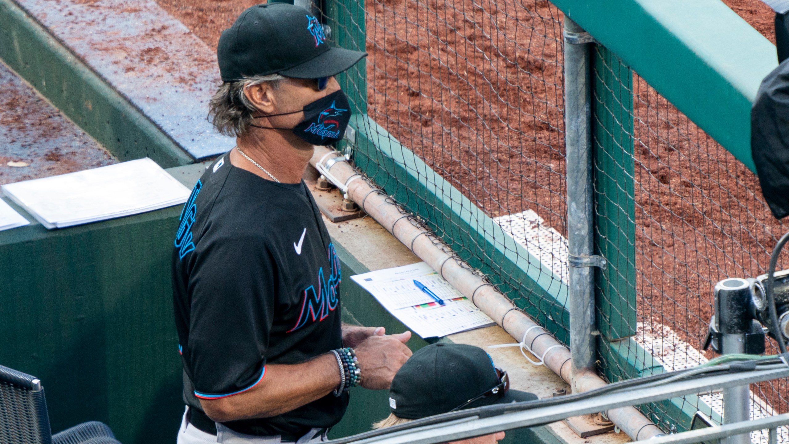 Miami Marlins' manager Don Mattingly looks out from the dugout during the eighth inning of a baseball game against the Philadelphia Phillies, Saturday, July 25, 2020, in Philadelphia. (AP Photo/Chris Szagola)