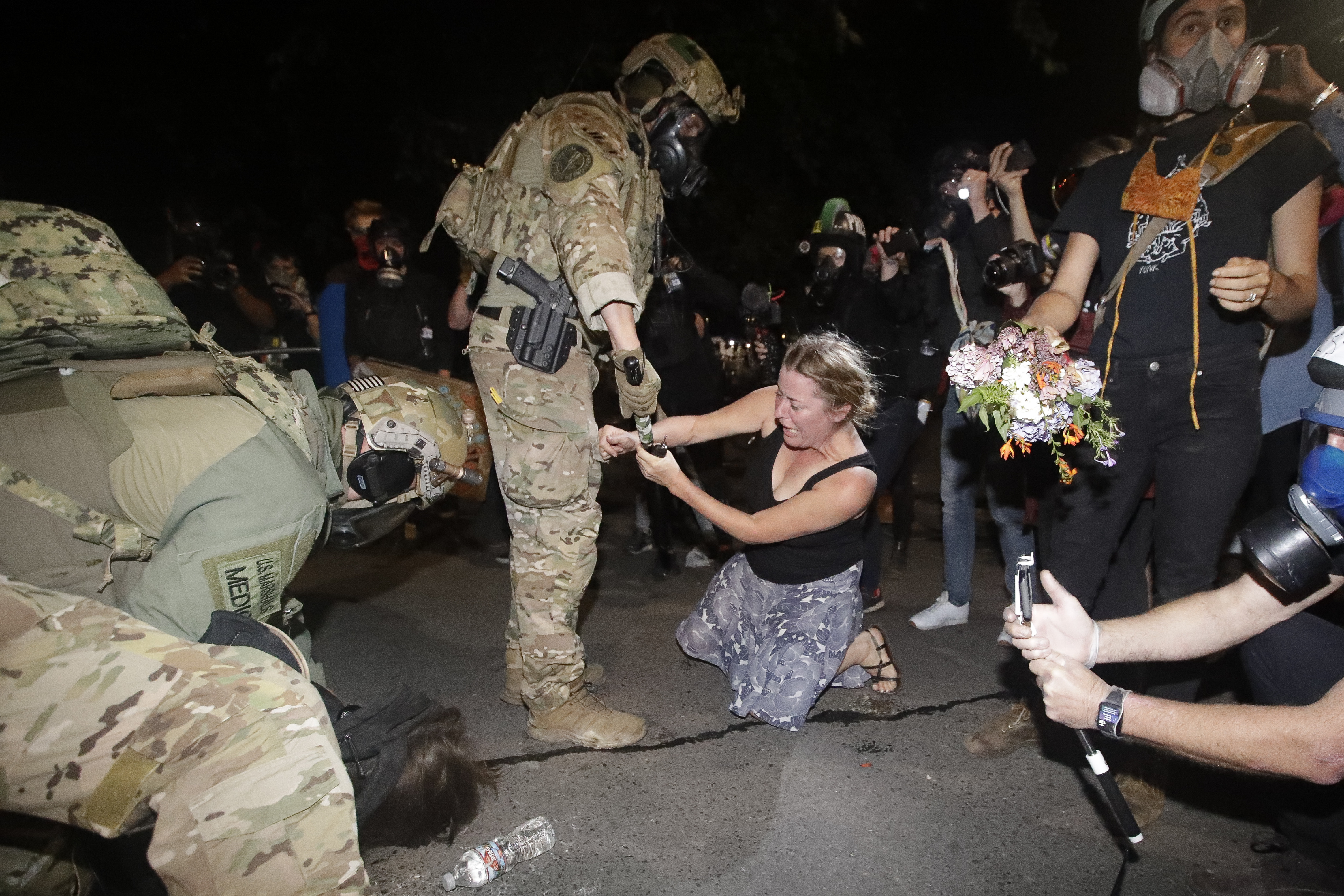 Demonstrators clash with federal officers during a Black Lives Matter protest at the Mark O. Hatfield United States Courthouse Monday, July 27, 2020, in Portland, Ore. (AP Photo/Marcio Jose Sanchez)