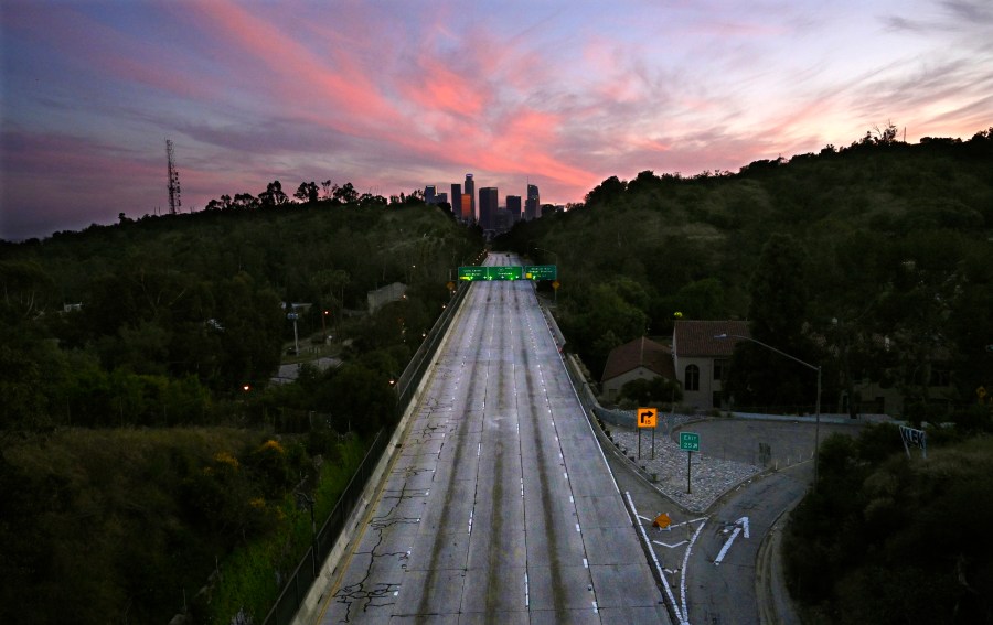 This April 26, 2020 file photo shows empty lanes of the 110 Arroyo Seco Parkway that leads to downtown Los Angeles during the coronavirus outbreak in Los Angeles. A record drop in U.S. energy consumption this spring was driven by less demand for coal that's burned for electricity and oil that's refined into gasoline and jet fuel. (AP Photo/Mark J. Terrill, File)