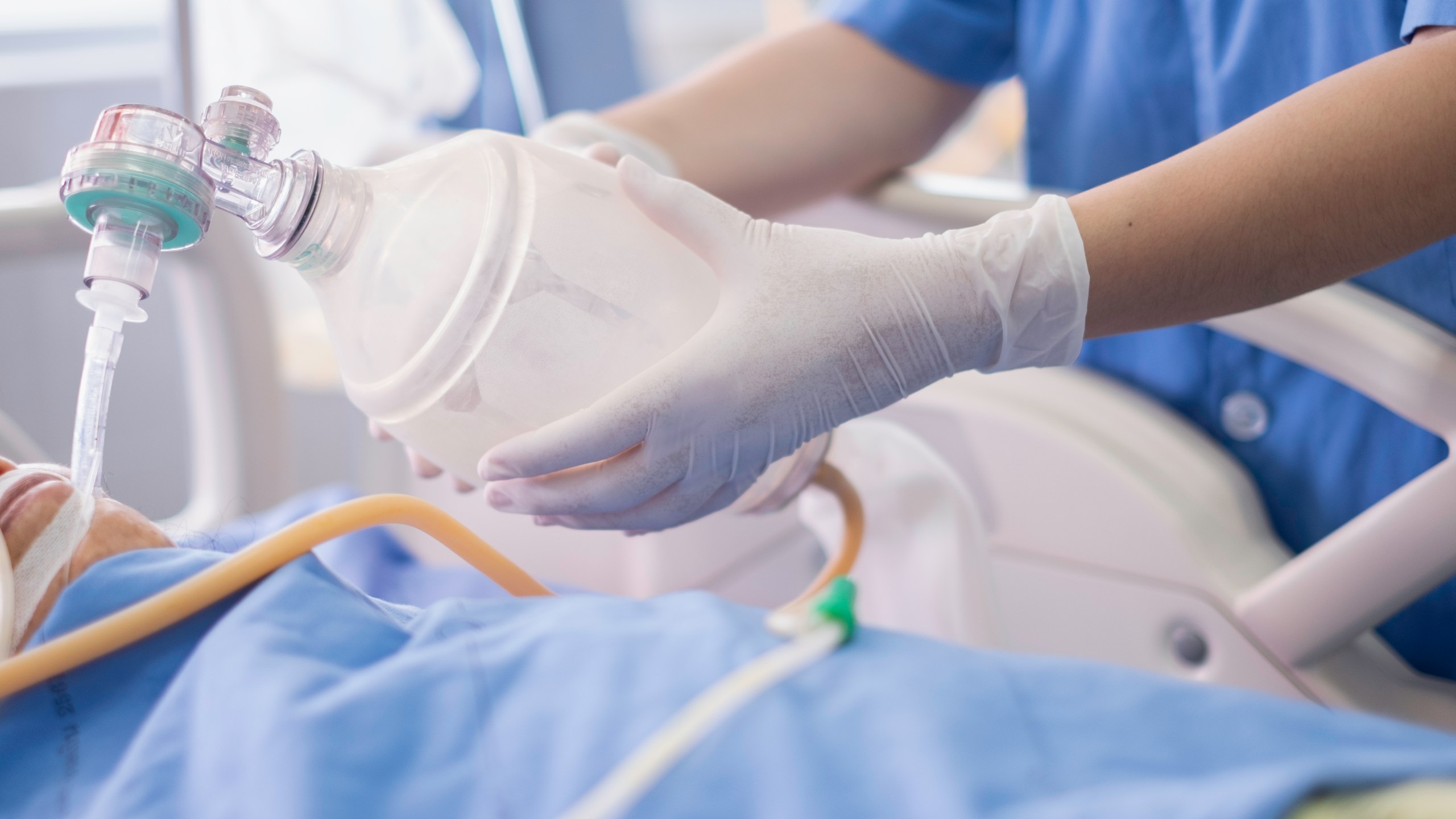 This file photo shows a doctor holding an oxygen Ambu bag over a patient given oxygen by intubation tube in an ICU. (Getty Images)