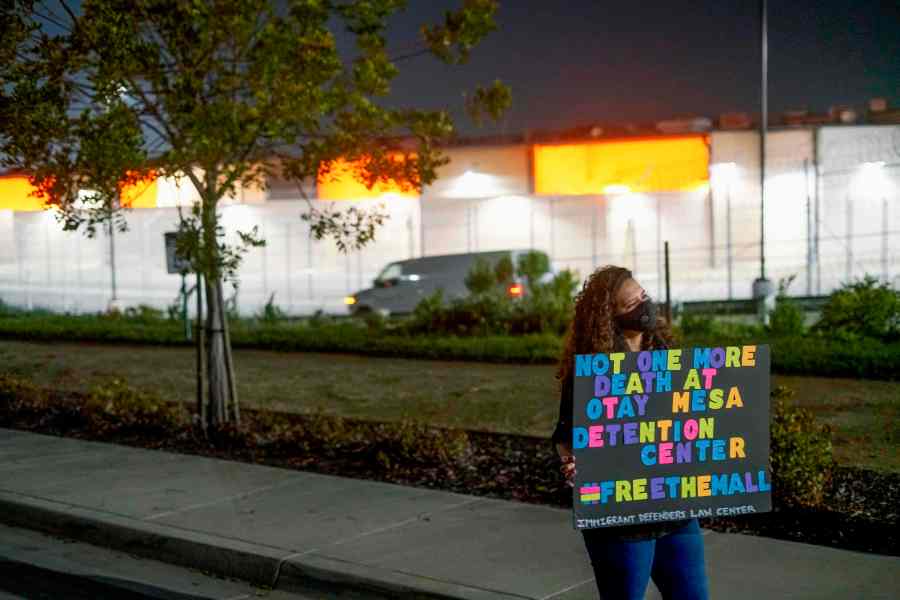 A Protester stands outside the Otay Mesa Detention Center during a "Vigil for Carlos" rally on May 9, 2020. The vigil was held to commemorate Carlos Ernesto Escobar Mejia, the first immigrant who died of COVID-19 related symptoms while being held at the detention Center. (SANDY HUFFAKER / AFP via Getty Images)