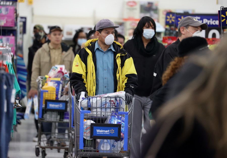 People wearing masks and gloves wait to checkout at Walmart on April 3, 2020, in Uniondale, New York. (Al Bello/Getty Images)