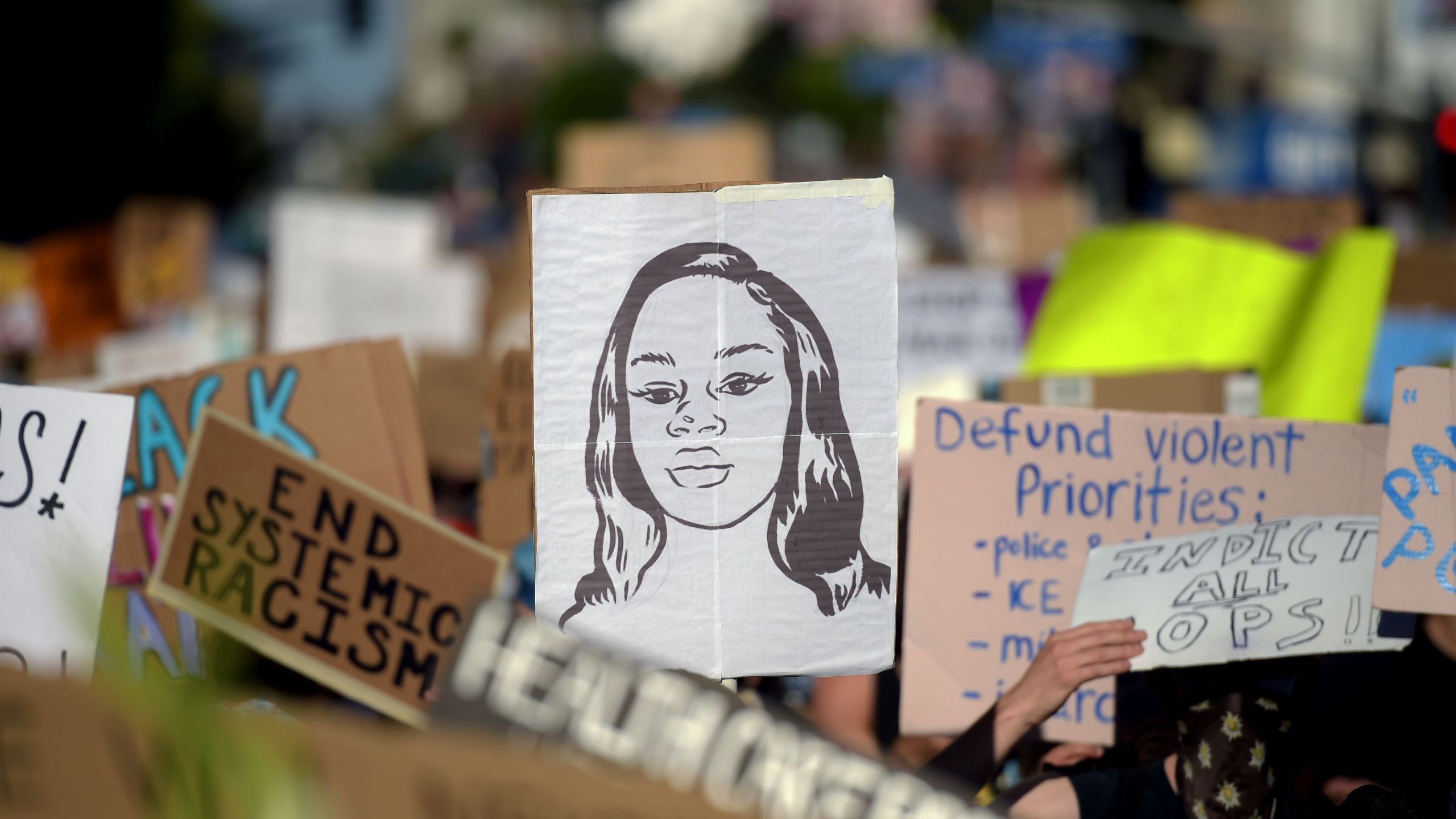 Protesters march holding placards and a portrait of Breonna Taylor during a demonstration against racism and police brutality in Hollywood on June 7, 2020. (Agustin Paullier / AFP / Getty Images)