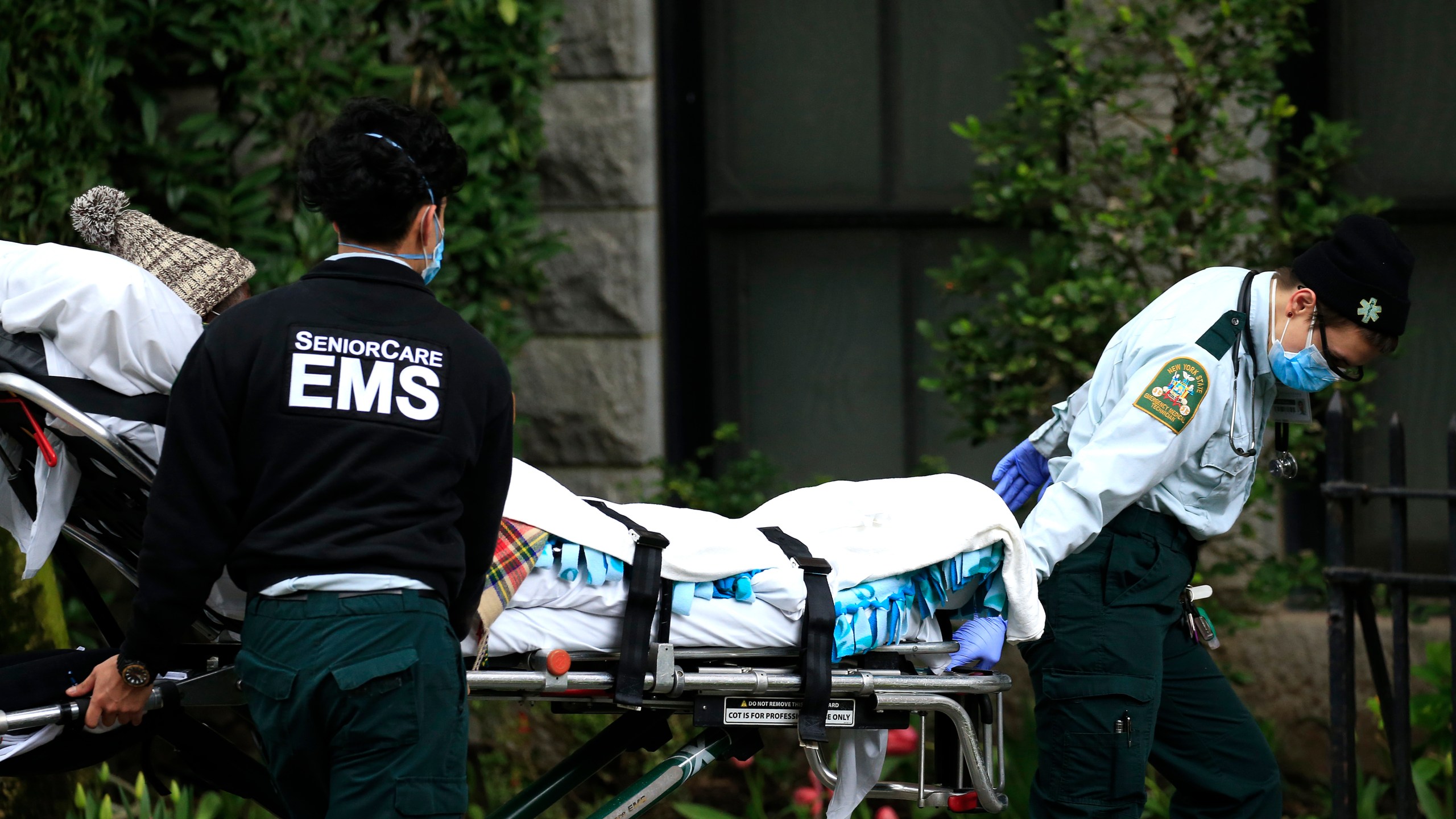 Emergency Medical Service workers unload a patient out of their ambulance at the Cobble Hill Health Center on April 18, 2020, in the Cobble Hill neighborhood of the Brooklyn borough of New York City. (Justin Heiman/Getty Images)