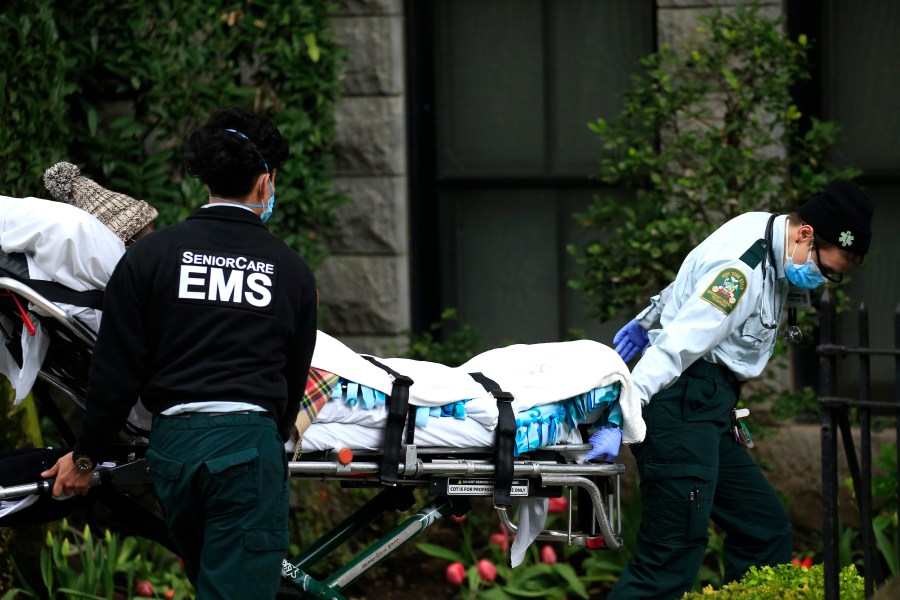 Emergency Medical Service workers unload a patient out of their ambulance at the Cobble Hill Health Center on April 18, 2020, in the Cobble Hill neighborhood of the Brooklyn borough of New York City. (Justin Heiman/Getty Images)