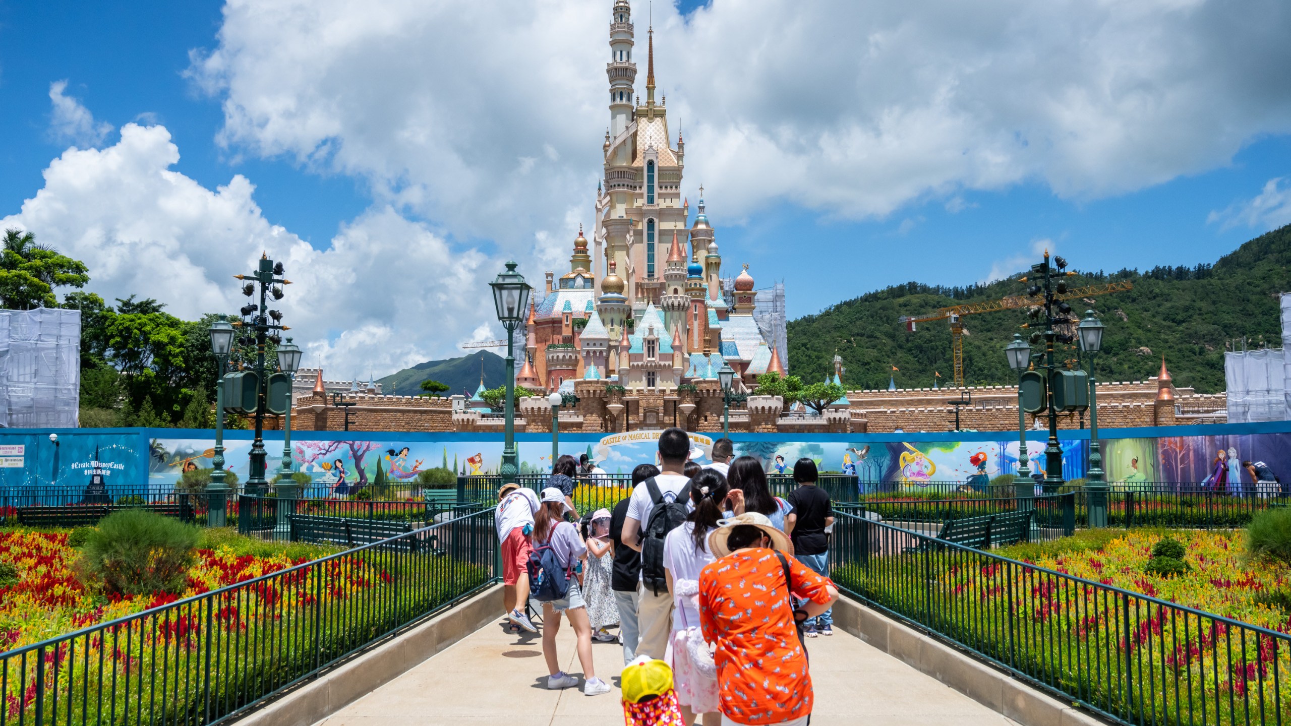 Visitors take photos of the Castle of Magical Dreams at Hong Kong Disneyland on June 18, 2020. (Billy H.C. Kwok/Getty Images)