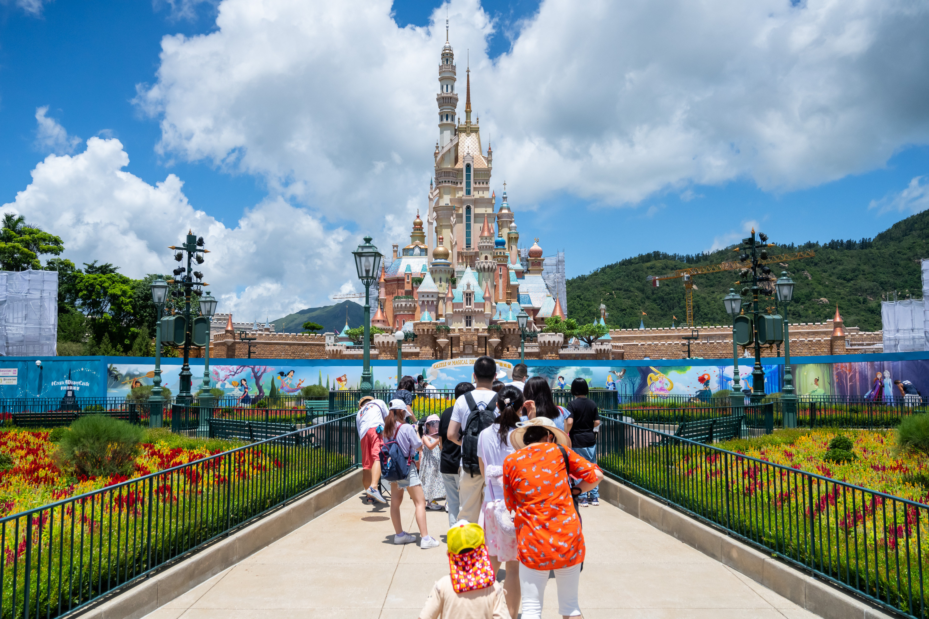 Visitors take photos of the Castle of Magical Dreams at Hong Kong Disneyland on June 18, 2020. (Billy H.C. Kwok/Getty Images)