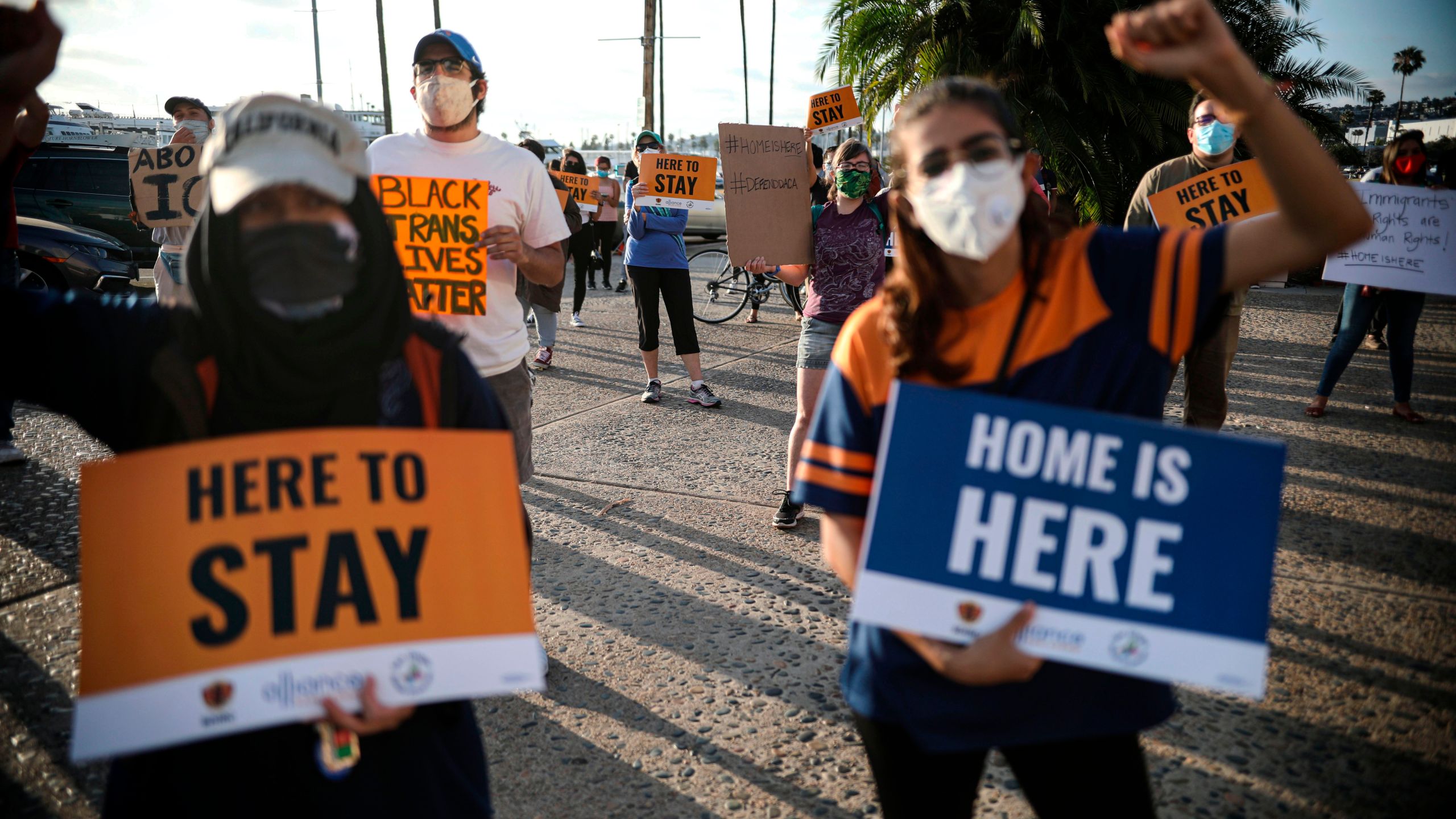 People hold signs during a rally in support of the Supreme Court's ruling in favor of the Deferred Action for Childhood Arrivals (DACA) program, in San Diego on June 18, 2020. (SANDY HUFFAKER/AFP via Getty Images)