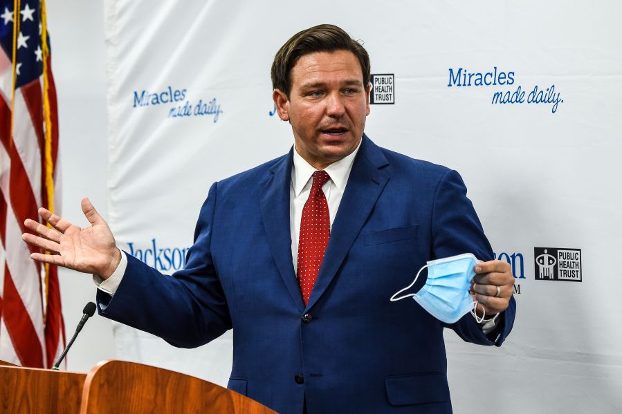 Florida Gov. Ron DeSantis speaks holding his facemask during a press conference to address the rise of coronavirus cases in the state, at Jackson Memorial Hospital in Miami on July 13, 2020. (CHANDAN KHANNA/AFP via Getty Images)