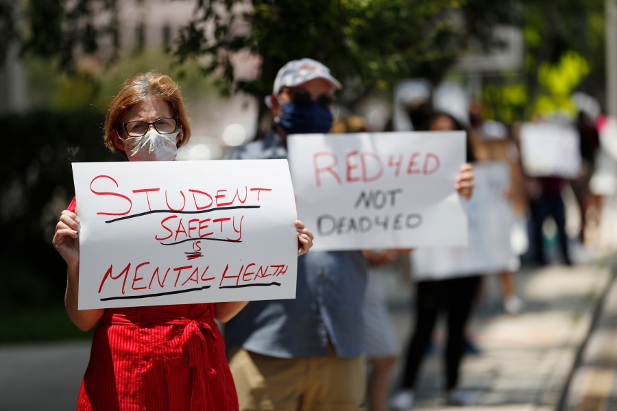 School counselor Laura Hottenstein stands in protest along with other teachers and counselors in front of the Hillsborough County Schools District Office on July 16, 2020 in Tampa, Florida. Teachers and administrators from Hillsborough County Schools rallied against the reopening of schools due to health and safety concerns amid the COVID-19 pandemic. (Octavio Jones/Getty Images)