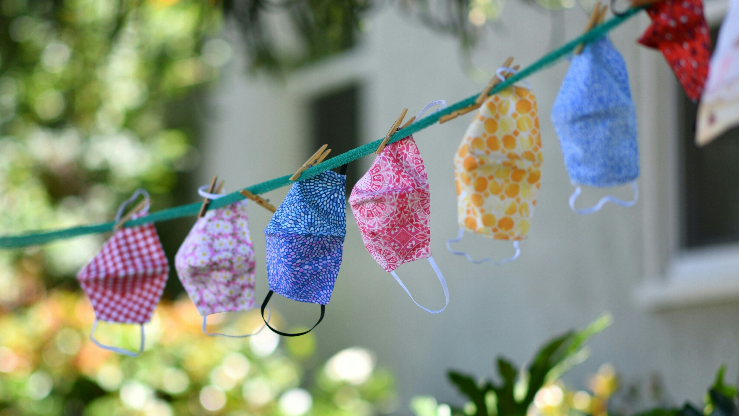 This file photo shows masks displayed on a clothesline for sale in the front yard of a house in Los Angeles on July 20, 2020. (CHRIS DELMAS/AFP via Getty Images)