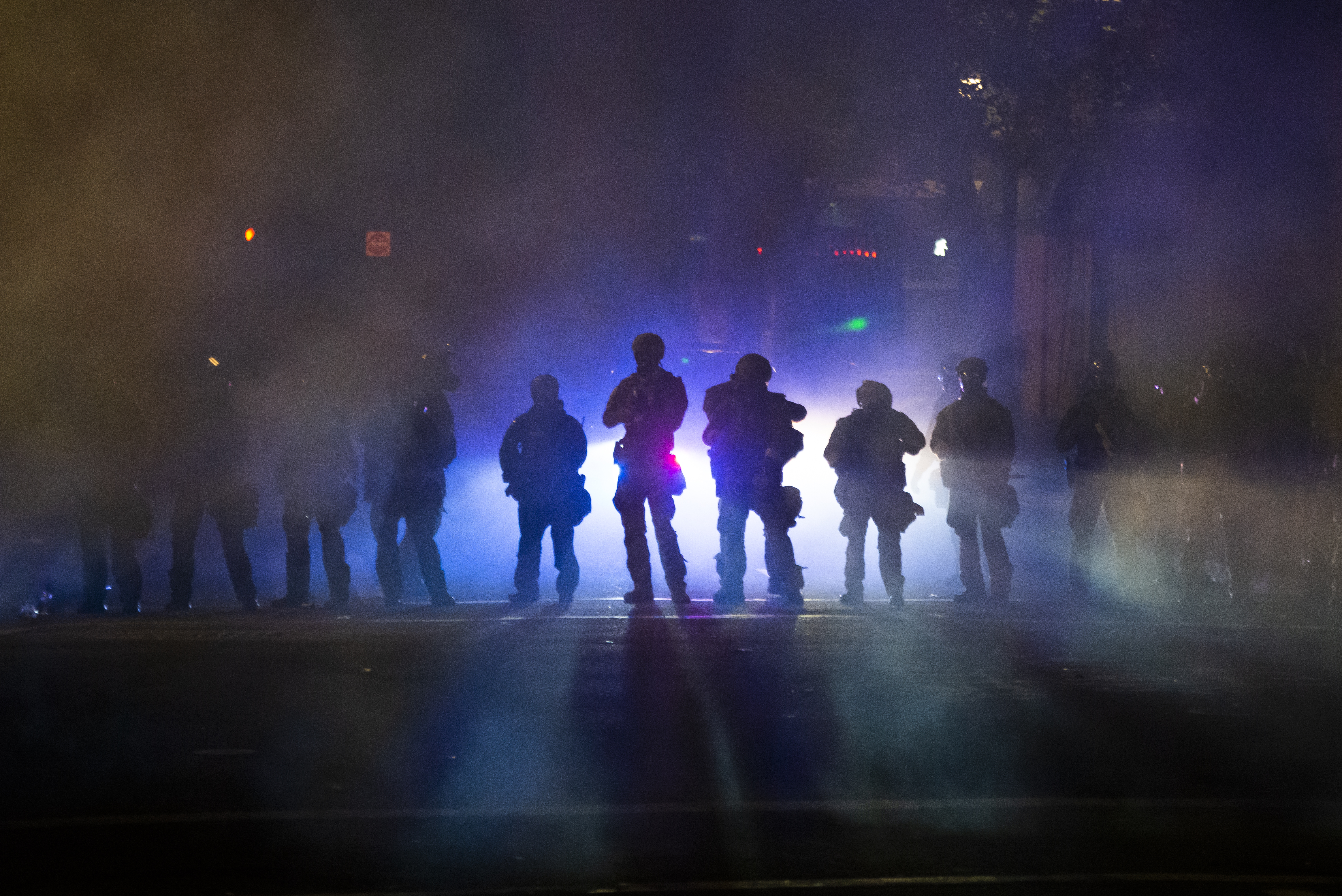 Federal officers walk through tear gas while dispersing a crowd of about a thousand people during a protest at a federal courthouse in Portland, Oregon, on July 21, 2020. (Nathan Howard / Getty Images)