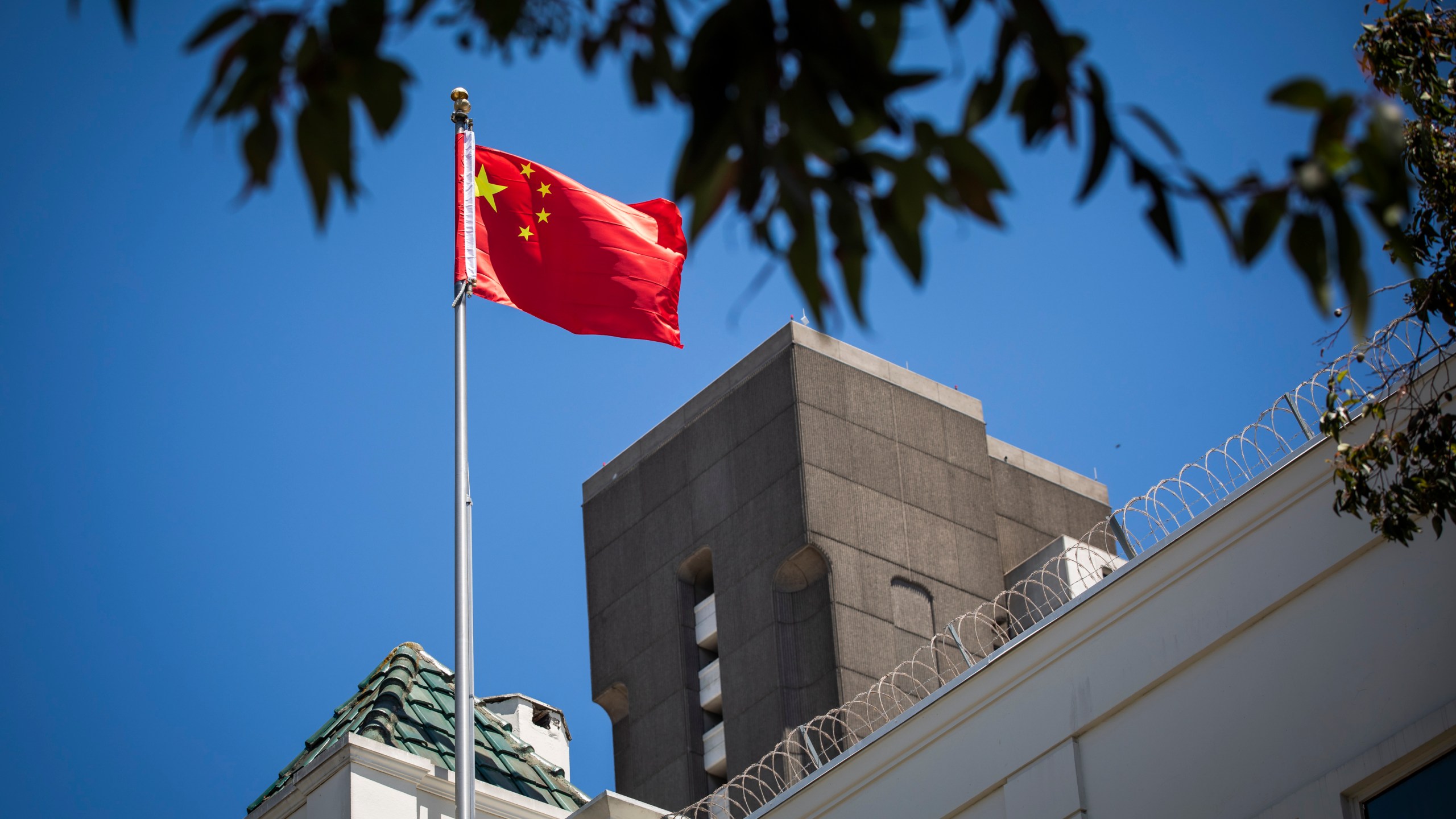 The flag of the People's Republic of China flies in the wind above the Consulate General of the People's Republic of China in San Francisco, on July 23, 2020. The U.S. Justice Department announced on July 23, 2020, the indictments of four Chinese researchers it said lied about their ties to the People's Liberation Army, with one escaping arrest by taking refuge in the country's San Francisco consulate. (Philip Pacheco / AFP via Getty Images)