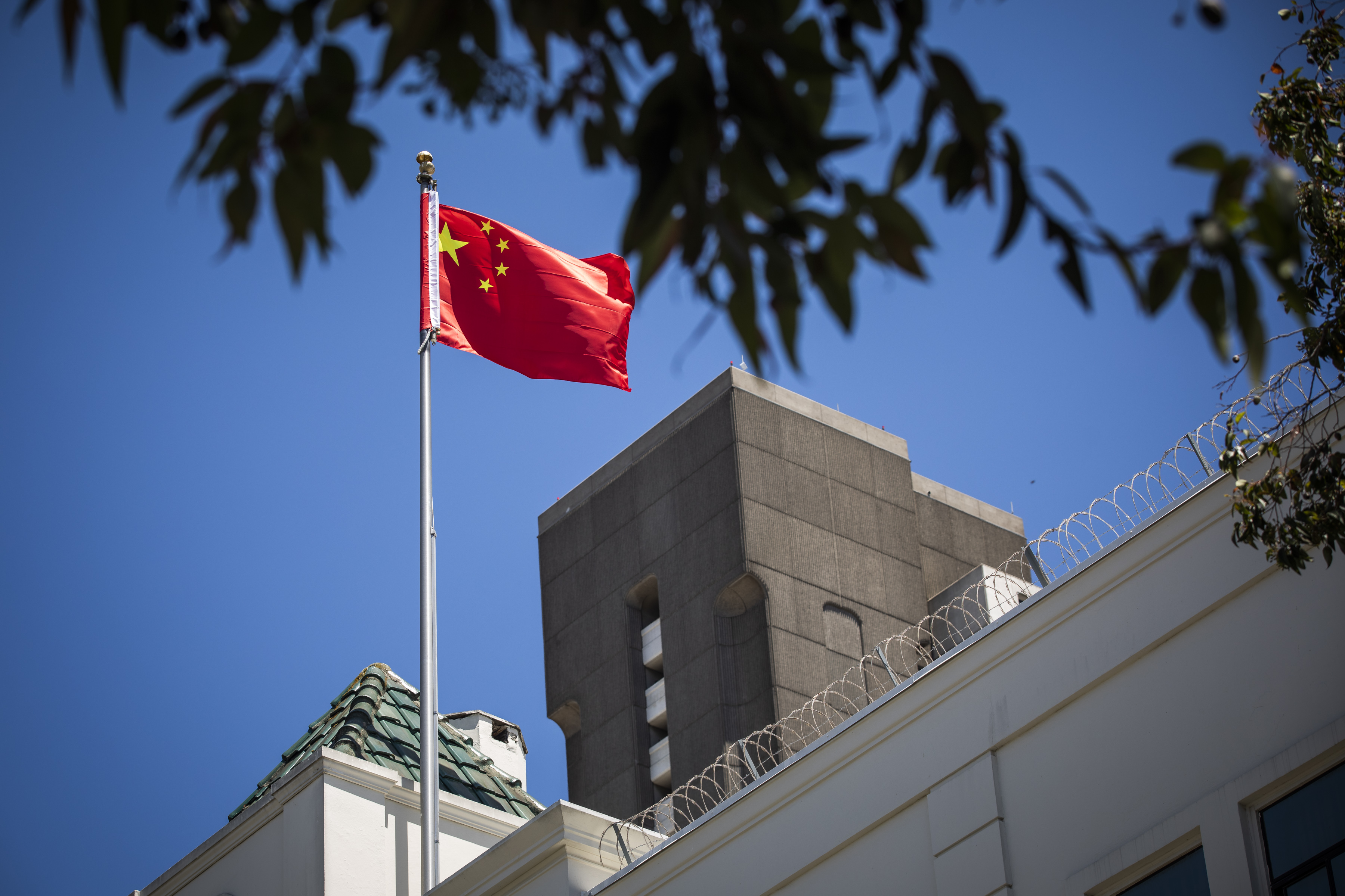 The flag of the People's Republic of China flies in the wind above the Consulate General of the People's Republic of China in San Francisco, on July 23, 2020. The U.S. Justice Department announced on July 23, 2020, the indictments of four Chinese researchers it said lied about their ties to the People's Liberation Army, with one escaping arrest by taking refuge in the country's San Francisco consulate. (Philip Pacheco / AFP via Getty Images)