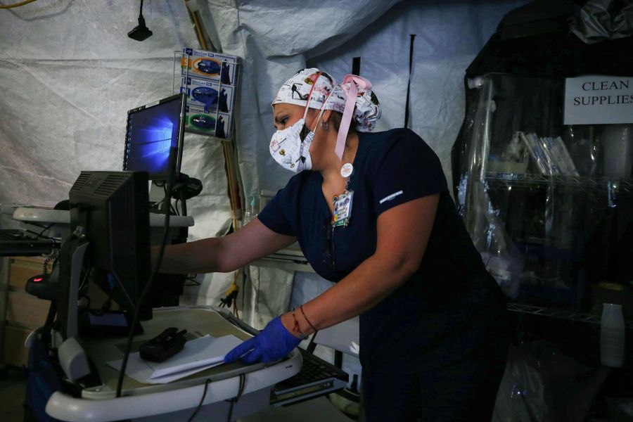 A nurse works in a makeshift tent triage center for patients suspected of being COVID-19 positive outside El Centro Regional Medical Center in hard-hit Imperial County on July 21, 2020. (Mario Tama/Getty Images)