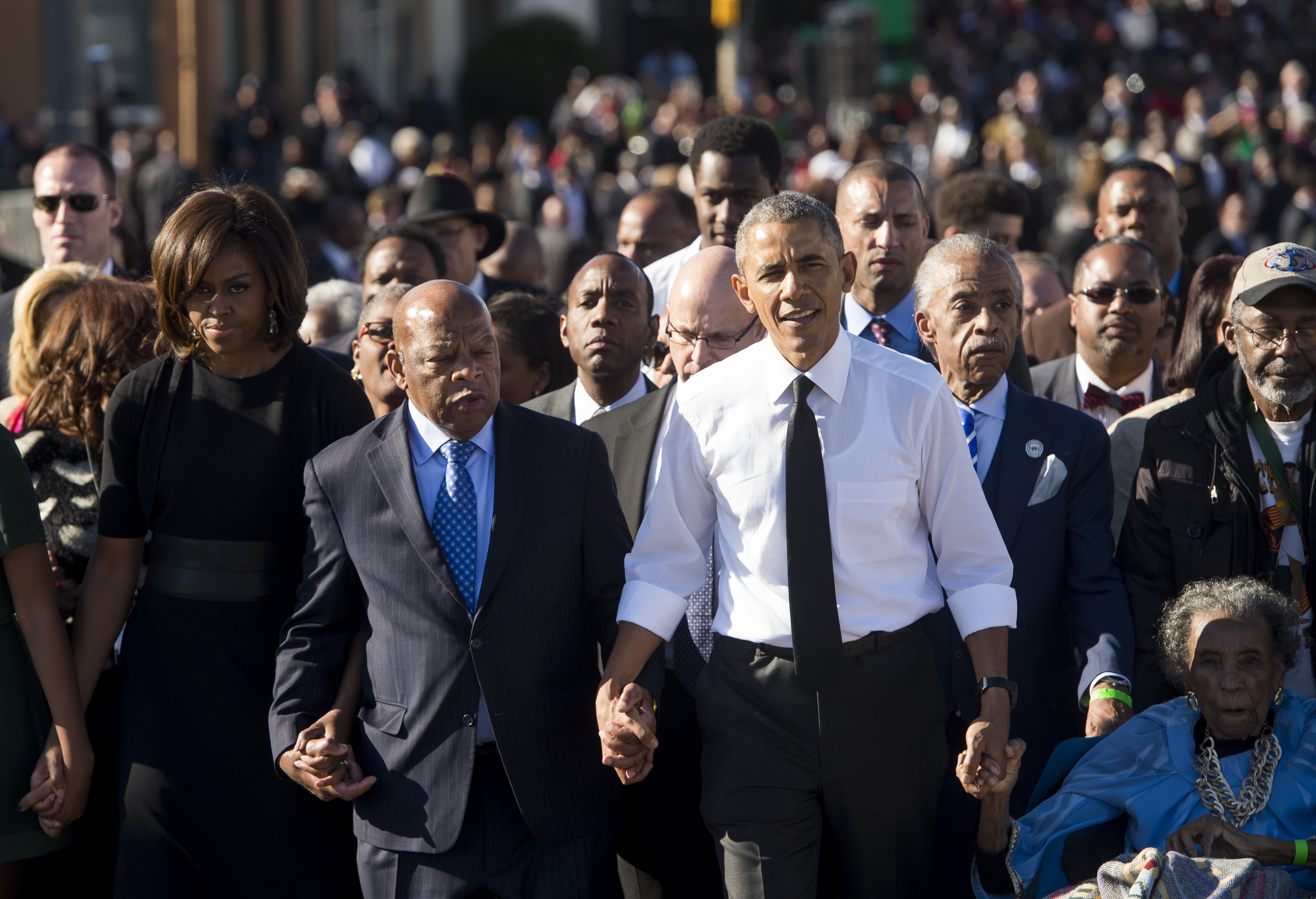 Barack Obama walks alongside Michele Obama and Rep. John Lewis across the Edmund Pettus Bridge to mark the 50th Anniversary of the Selma to Montgomery civil rights marches in Selma, Alabama, March 7, 2015. (SAUL LOEB/AFP via Getty Images)