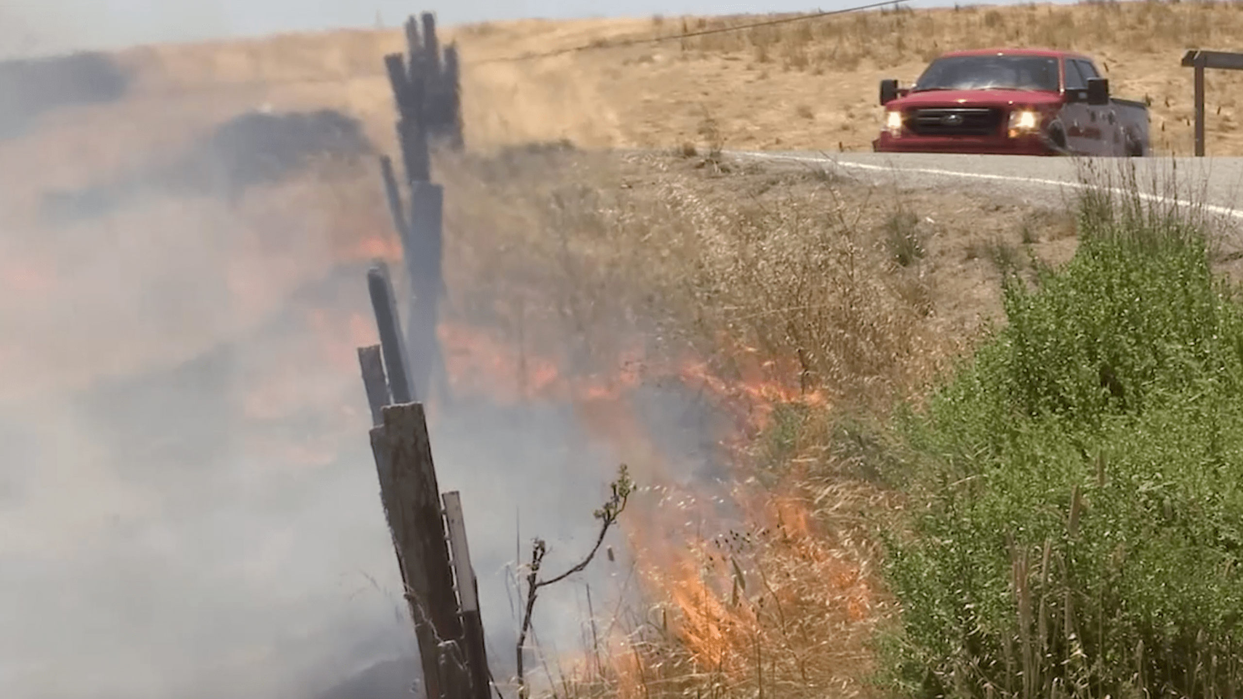 A pickup truck drives in the area of the Crews Fire outside Gilroy on July 6, 2020. (KRON)