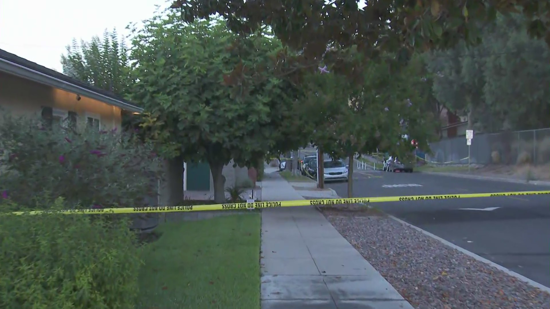 A crime scene tape surrounds a home where a deadly shooting investigation was underway on July 21, 2020. (KTLA)