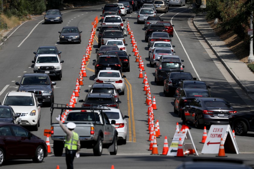 Cars line up for drive-through coronavirus testing at Dodger Stadium in Los Angeles. (Gary Coronado / Los Angeles Times)