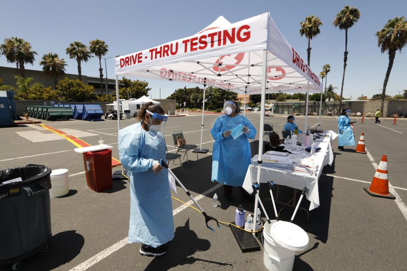 At the Anaheim Convention Center, medical staff administer COVID-19 test kits on July 15, 2020. (Carolyn Cole / Los Angeles Times)