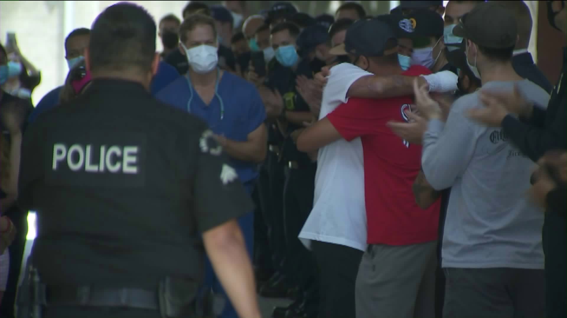 LAFD Capt. Victor Aguirre is embraced on July 21, 2020, upon is released from the hospital. (KTLA)