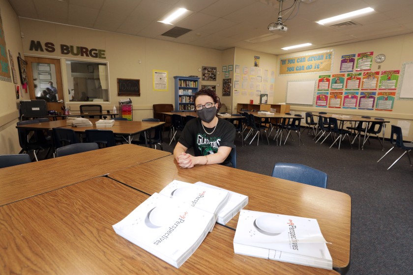 Natalie Burge, a teacher at Giano Intermediate School in West Covina, sits in her empty classroom. Officials are debating whether to reopen campuses in the fall. (Myung J. Chun / Los Angeles Times)