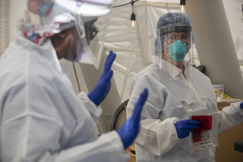 Nurses Janil Wise, left, and Melinda Gruman, work in the OB triage tent at Providence Holy Cross Medical Center in Mission Hills on July 10, 2020. (Brian van der Brug / Los Angeles Times)