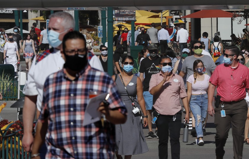 Visitors walk through Downtown Disney in Anaheim for its reopening on July 9, 2020. (KTLA)