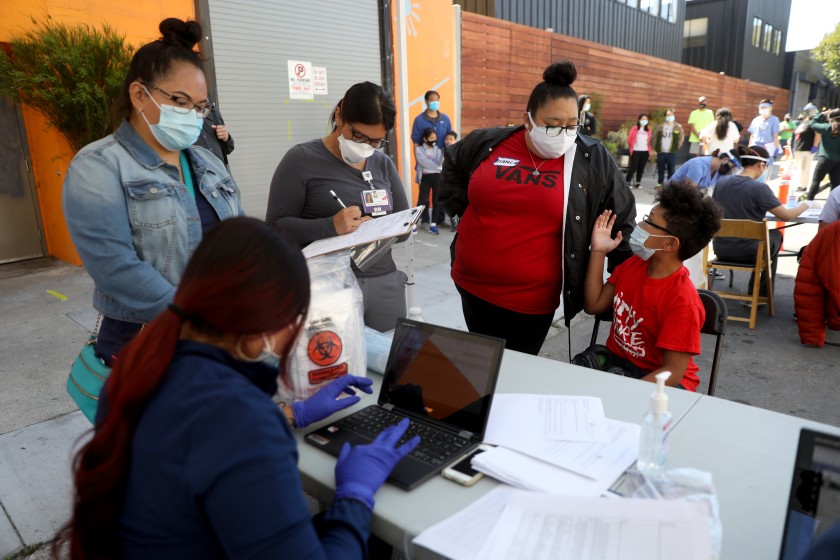 Residents sign up for COVID-19 testing administered by the Latino Task Force and the Department of Public Health in San Francisco’s Mission District in this undated photo. (Gary Coronado / Los Angeles Times)