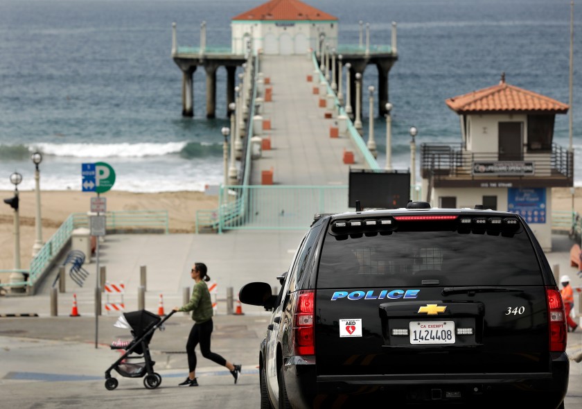 Manhattan Beach police maintain a presence at the Manhattan Beach Pier on April 7, 2020. (Christina House / Los Angeles Times)