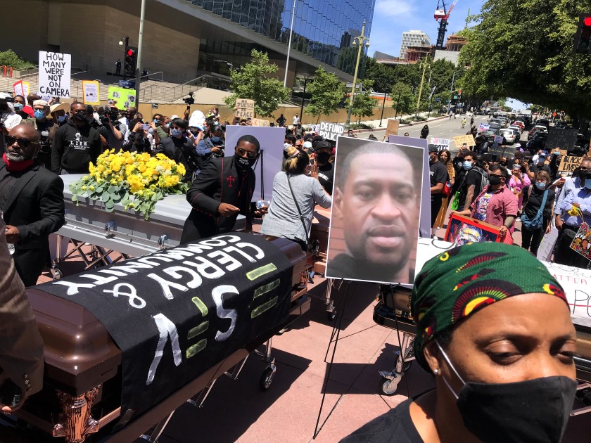 Protesters display four coffins in memory of George Floyd and others killed by police nationwide in downtown Los Angeles in June 2020. (Genaro Molina /Los Angeles Times)