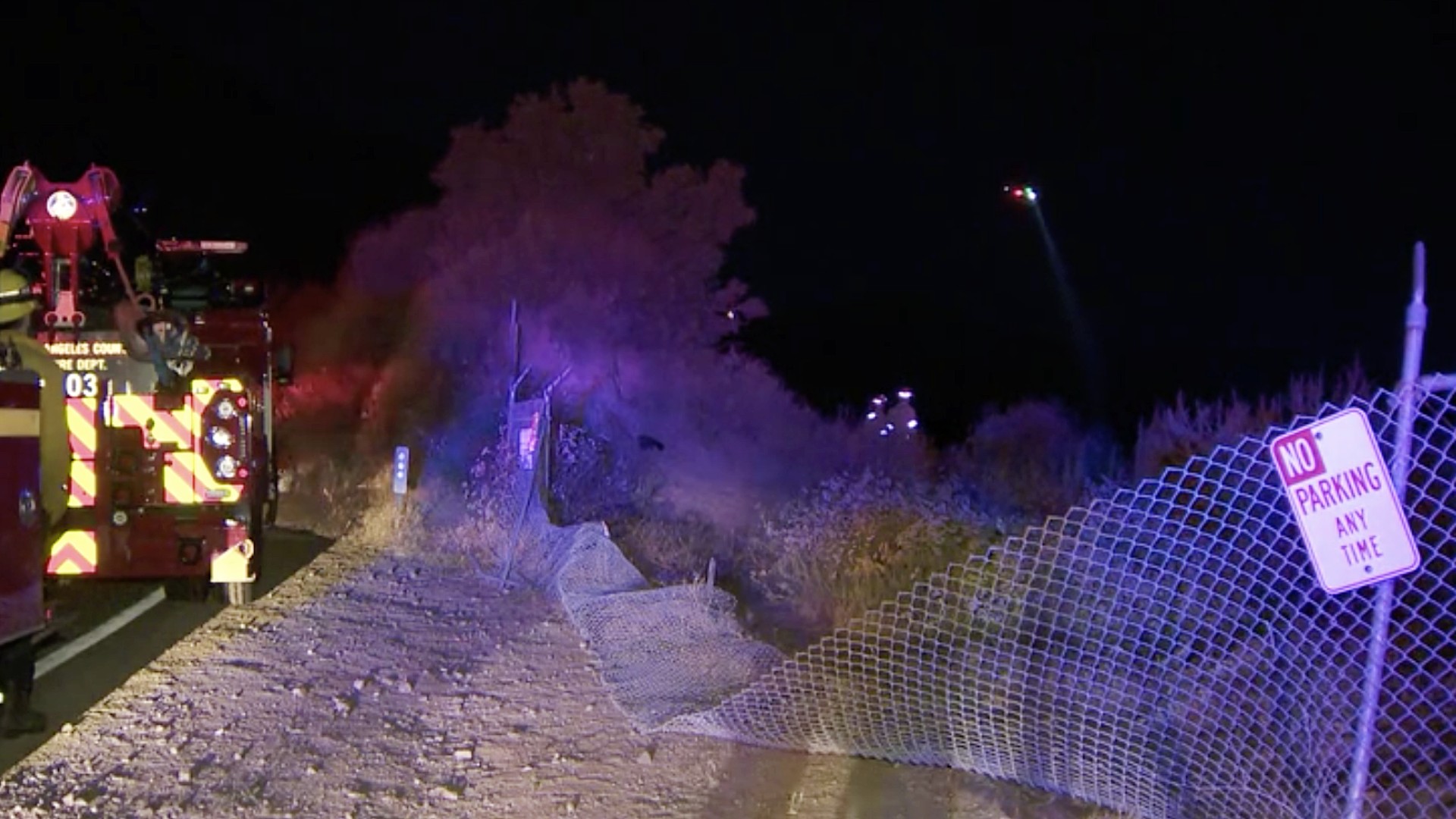 A damaged fence is seen where a car went over the side of a hill near the San Gabriel Dam on July 2, 2020. (KTLA)