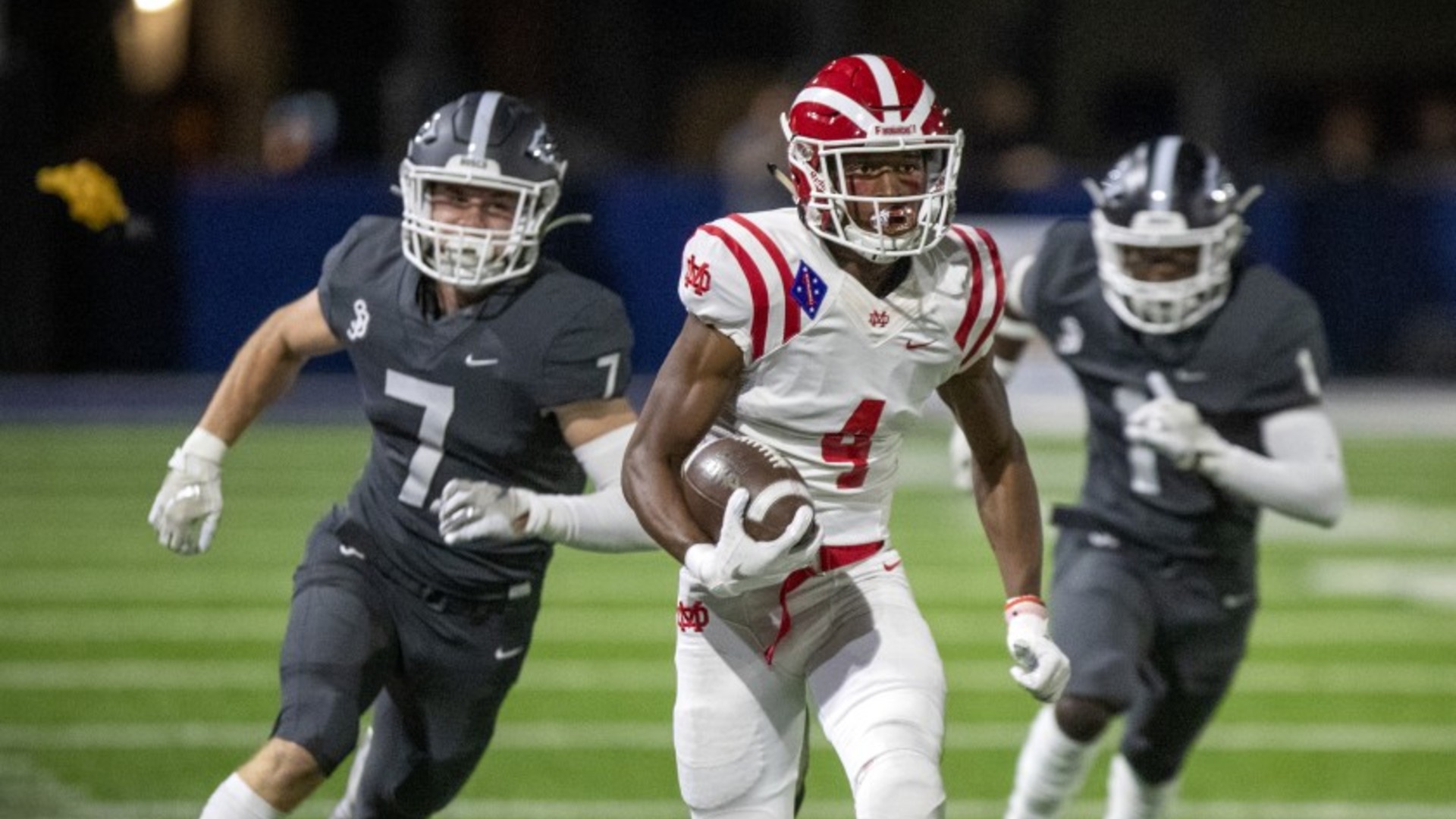 St. John Bosco’s Jake Newman, left, and Josh Alford pursue Mater Dei receiver Kody Epps in Bellflower, Calif., on Oct. 25, 2019. The 2020 high school sports season will be delayed.(Allen J. Schaben / Los Angeles Times)