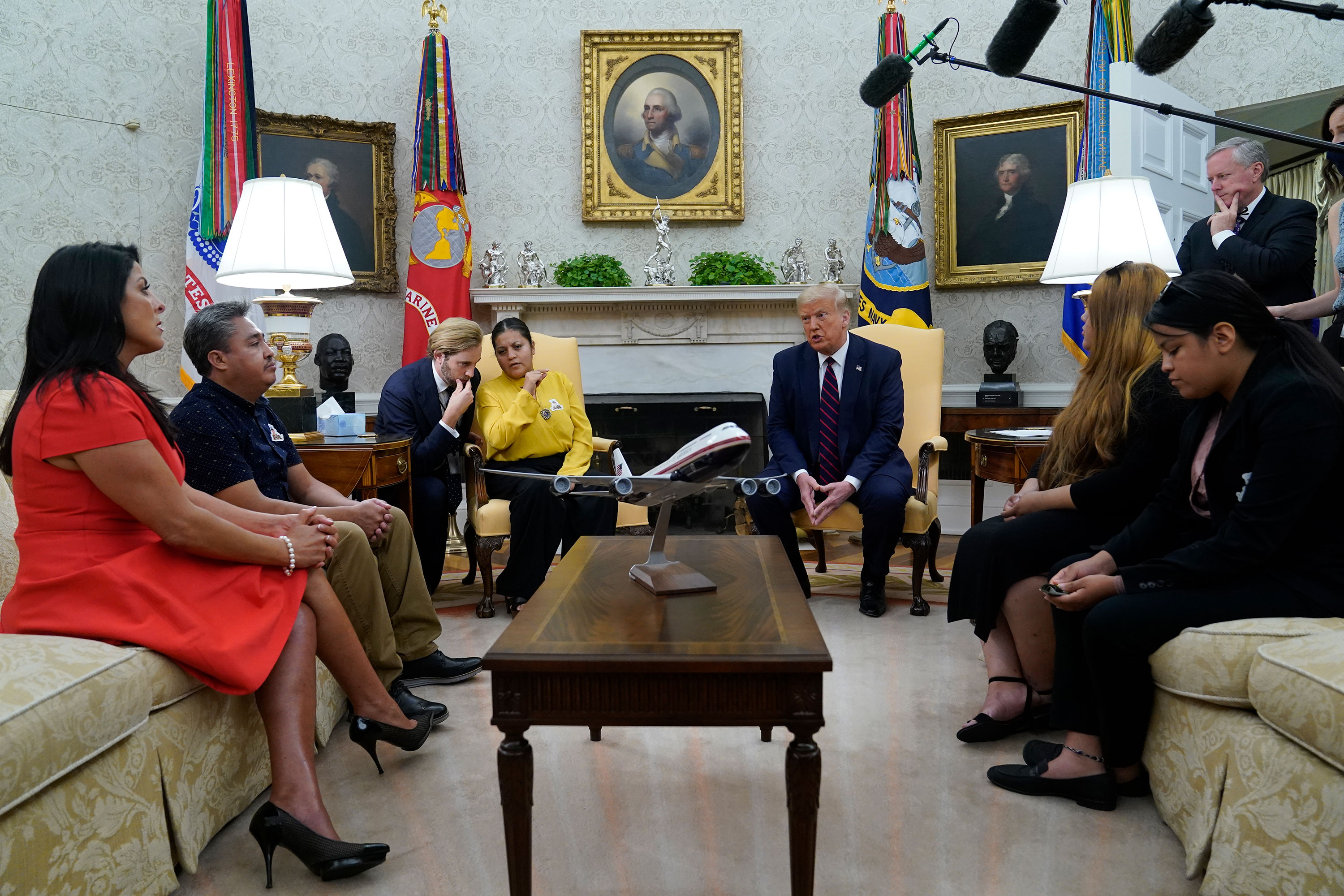 President Donald Trump speaks as he meets with the family of slain Army Spc. Vanessa Guillen in the Oval Office of the White House on Thursday, July 30, 2020, in Washington. Seated from left, family attorney Natalie Khawam, Vanessa's father Rogelio Guillen, Vanessa's mother Gloria Guillen, Trump, Vanessa's sister Mayra Guillen and Vanessa's sister Lupe Guillen. White House Chief of Staff Mark Meadows stands at top right. (AP Photo/Evan Vucci)