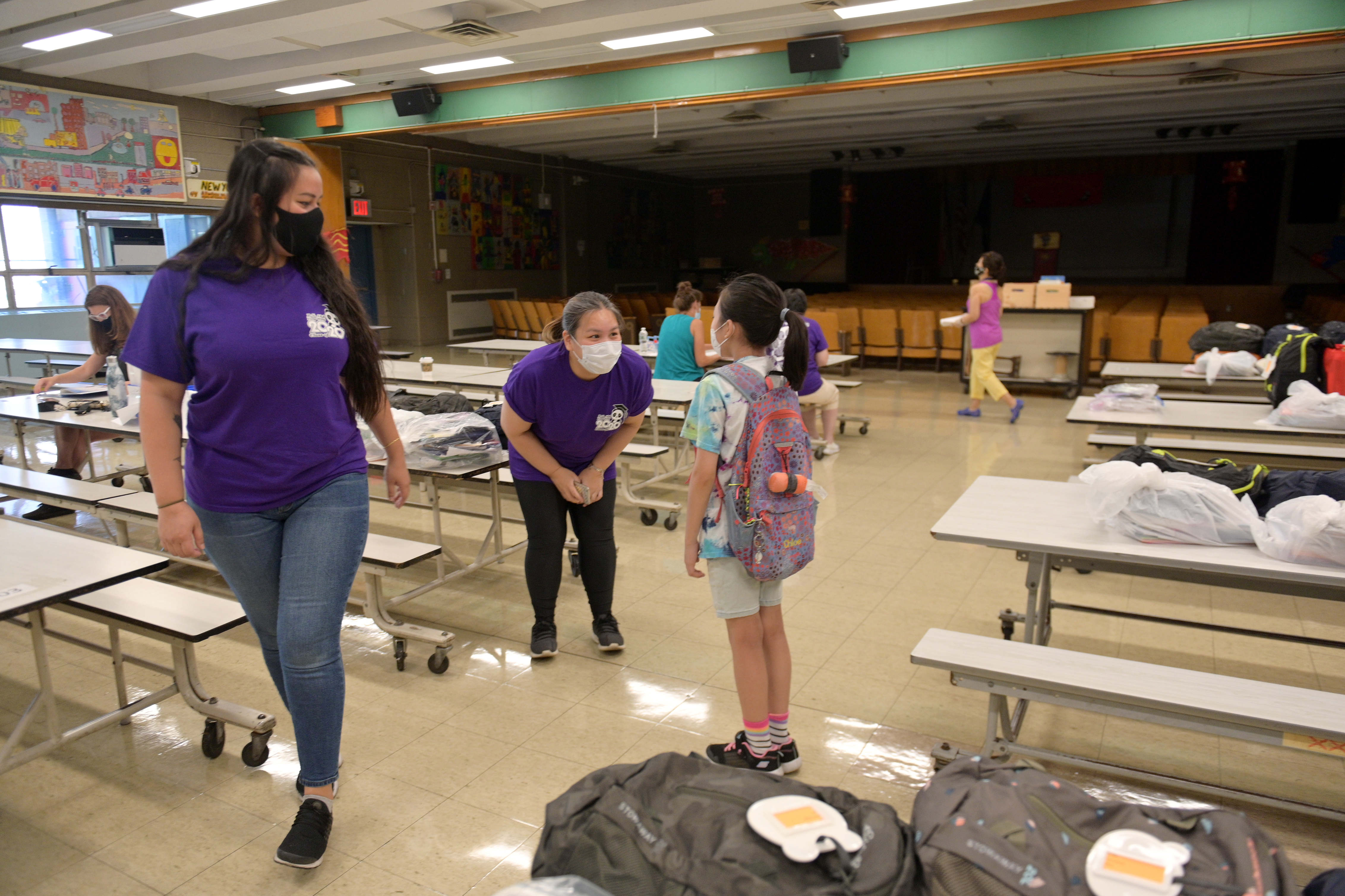 Teachers hand out graduation gifts at a New York City elementary school, not knowing when they will be back. (Michael Loccisano/Getty Images via CNN Wire)