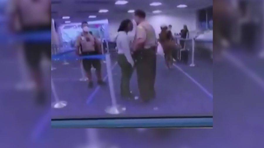 Termination proceedings have been initiated against a Miami-Dade police officer who struck a woman who he said struck him during an argument at Miami International Airport. (Twitter/Billy Corben via CNN Wire)