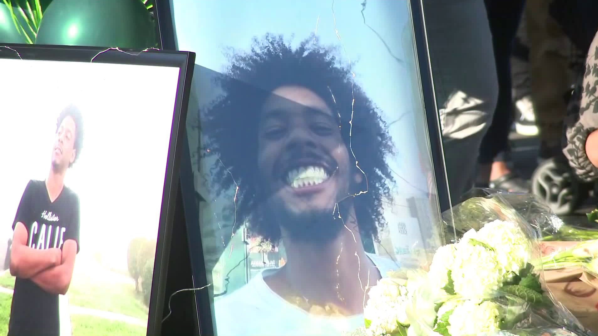 Photos of Jakeil Reynolds are displayed at a vigil held July 24, 2020, near where he was fatally shot days before in Ladera Heights. (KTLA)