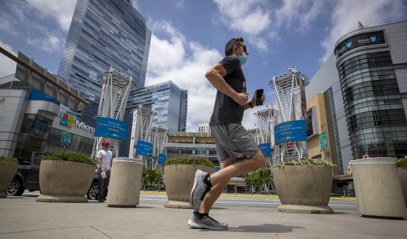 A jogger passes L.A. Live in downtown Los Angeles in June 2020.(Allen J. Schaben / Los Angeles Times)