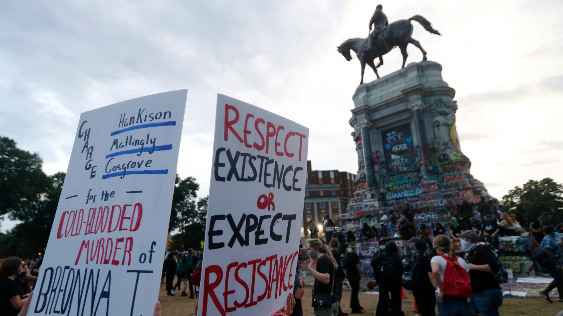 In this Tuesday June 23, 2020, file photo protesters gather near the statue of Confederate General Robert E. Lee on Monument Avenue in Richmond, Va. (AP Photo/Steve Helber, FILE)