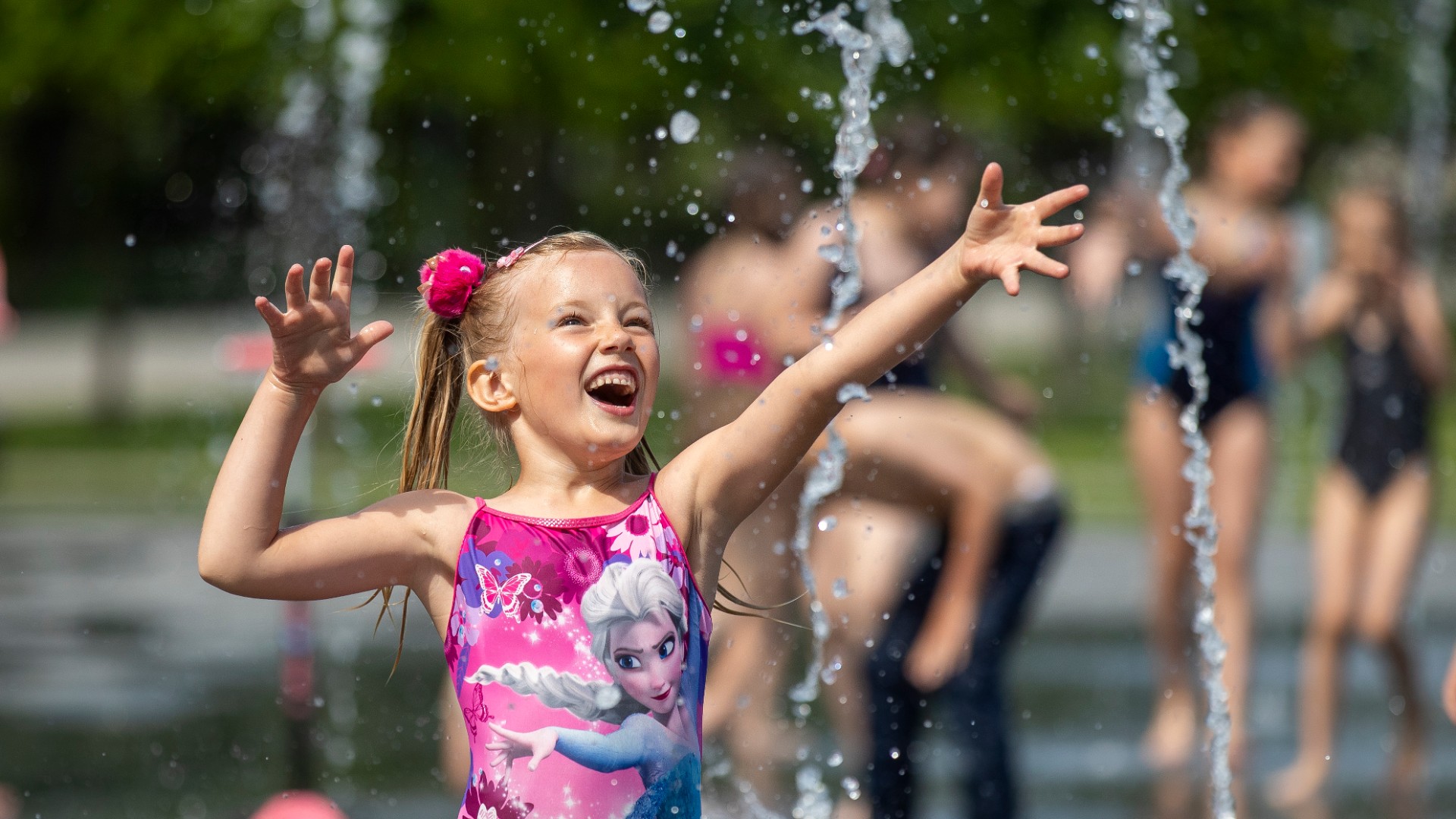 A child cools off in a public fountain in this file photo. (AP Photo/Mindaugas Kulbis)