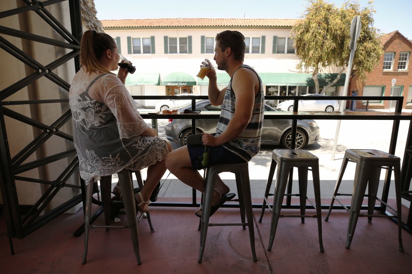 Matt and Leanne Harmon of Santa Clarita enjoy a beer at Ventura Coast Brewing Co. in this undated photo. (Al Seib / Los Angeles Times)