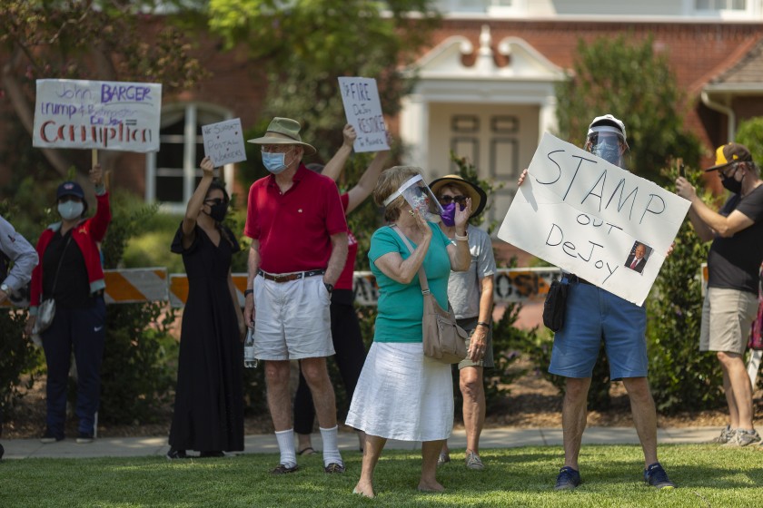 Protesters rally outside the home of USPS Board of Governors John M. Barger in San Marino on August 22, 2020, to decry recent U.S. Postal Service cuts by Postmaster General Louis DeJoy that could affect presidential election mail-in ballots. (David McNew/Getty Images)