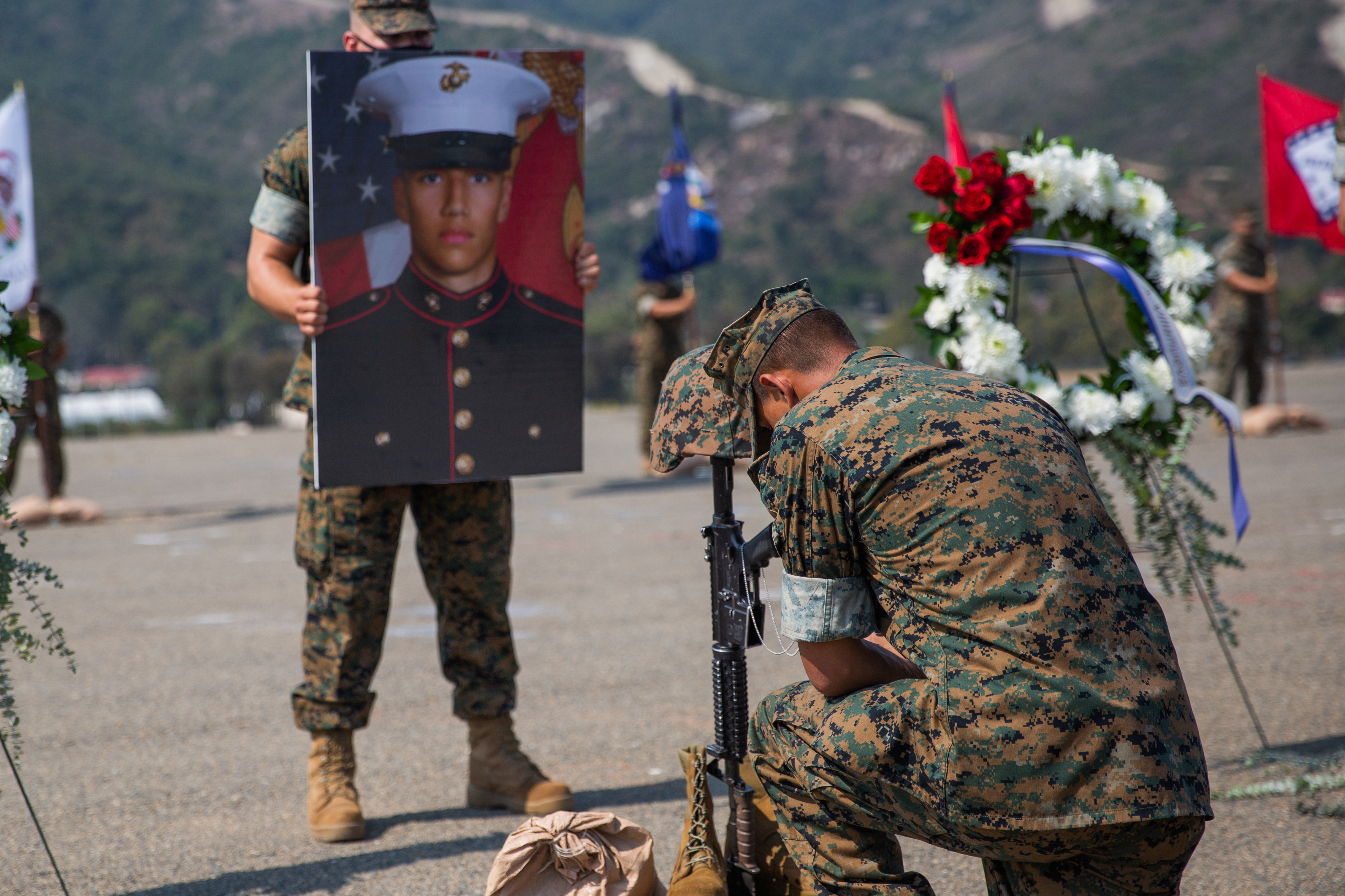 A U.S. Marine takes a knee to honor the fallen after a memorial service at Marine Corps Base Camp Pendleton, California, Aug. 21, 2020. The service was held in remembrance of the eight Marines and one Sailor from Bravo Company, Battalion Landing Team 1/4, 15th Marine Expeditionary Unit, who died in an assault amphibious vehicle mishap off the coast of San Clemente Island, California, July 30. (U.S. Marine Corps photo by Cpl. Jennessa Davey)